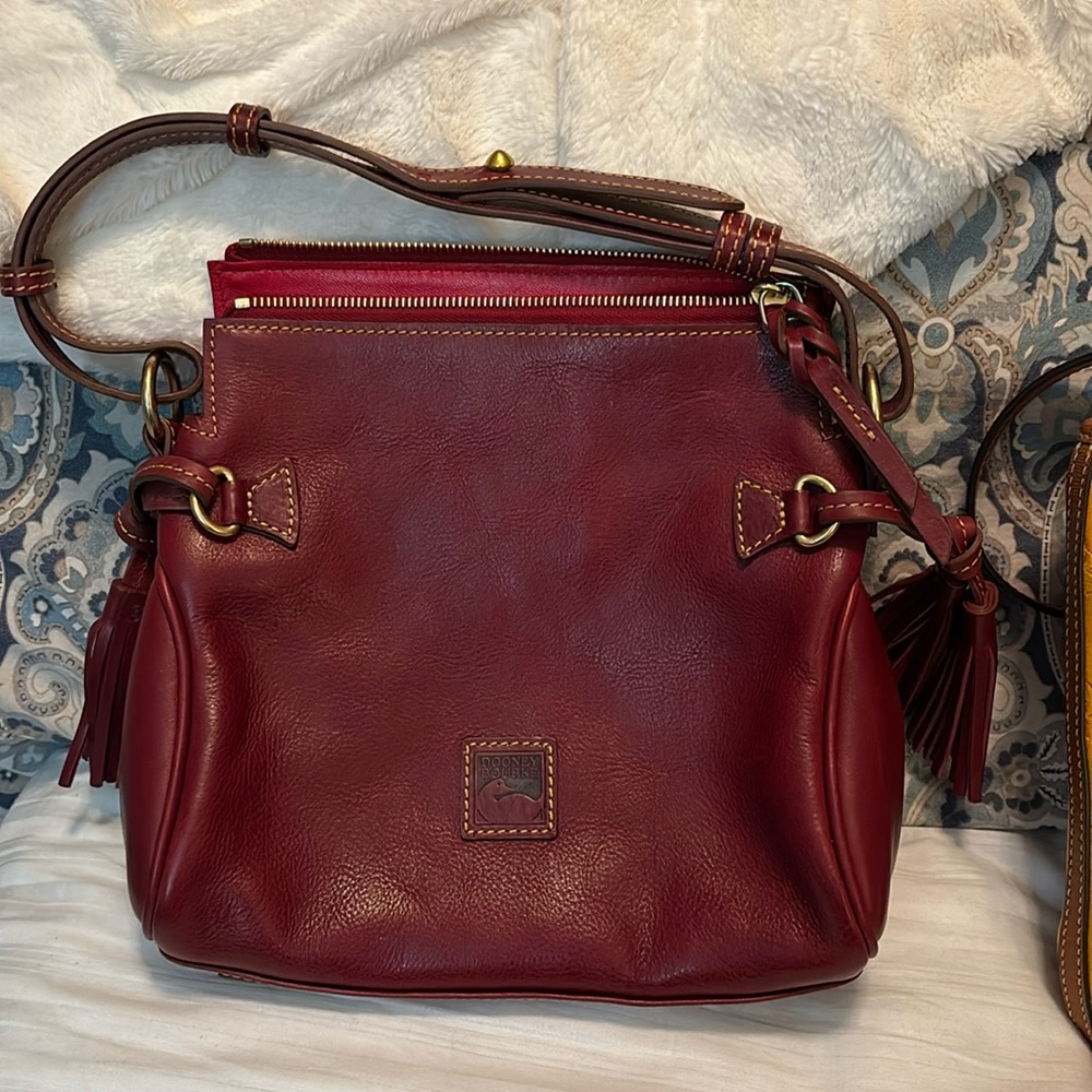 Wine/red colored Leather Dooney bag.  Excellent condition